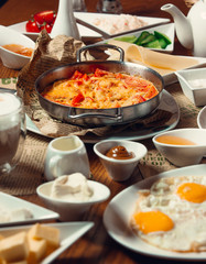 Traditional turkish breakfast with sunny side up eggs, nutella, egg dish menemen