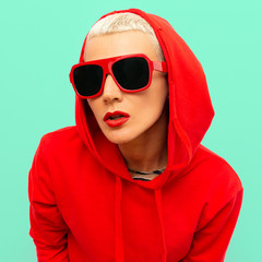 Fashion hipster model in Red sweatshirt hoodie and sunglasses street urban style