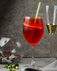 A glass of red juice with orange slice