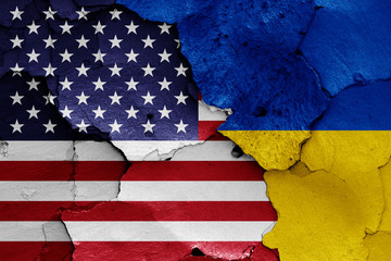 flags of USA and Ukraine painted on cracked wall