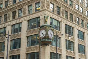 Fototapeta na wymiar Chicago downtown street view with old fashion clock on building facade