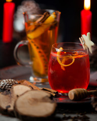 Cold red cocktail with orange zest in christmas table
