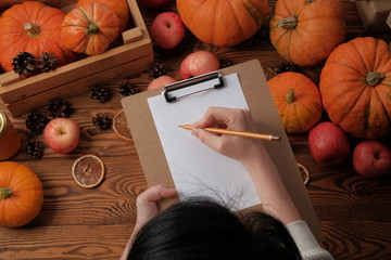 girl writes a list. thanksgiving concept.Top view