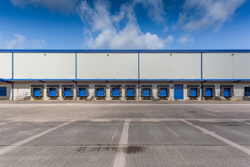 A large empty distribution warehouse with several loading bays