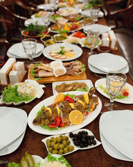Dinner table setup with fish, salads and side dishes