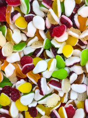 Multi-colored marmalade jelly candy dessert in the form of red and orange bears