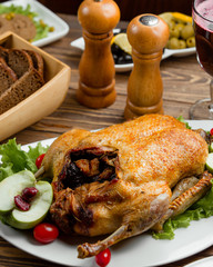 Roasted whole stuffed chicken served with bread and red wine