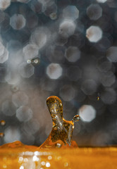 Frozen drops & splash of colored water liquid in high speed photography with a beautiful bokeh in the background