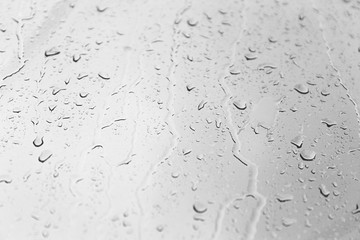 raindrops flowing down the glass