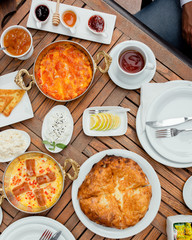 Top view of traditional azerbaijani breakfast with egg dishes, honey, jams, cheese