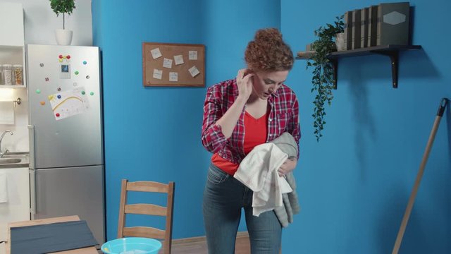 Woman puts things from the chair.