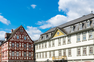 Fototapeta na wymiar white building with balcony and red half timbered house in Limburg an der Lahn, Germany