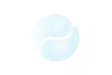Hydrogel patches for the eyes. White background. The concept of beauty, cosmetics for skin care around the eyes, lifting, beauty salon. Elimination of facial wrinkles. Minimalism, copyspace.