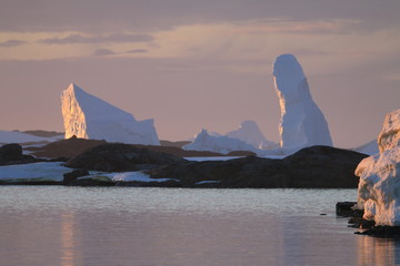 piękne naturalne formy z lodu i śniegu u wybrzeży antarktydy o zachodzie słońca - obrazy, fototapety, plakaty
