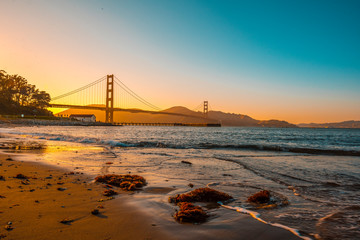 Golden Gate of San Francisco and its beautiful sunset from the beach. United States