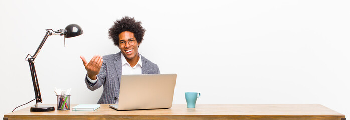 young black businessman feeling happy, successful and confident, facing a challenge and saying...