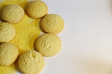 On a white background, useful sweet round corn cookies and corn grits.