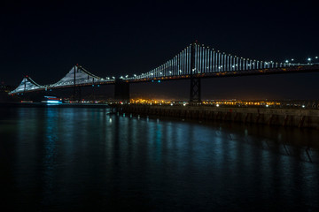 Naklejka na ściany i meble Long exposure at the San Francisco Bay Bridge at night. California