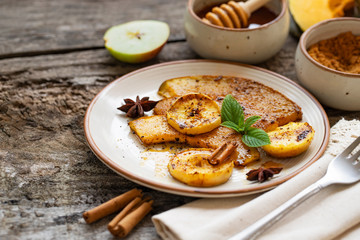 baked spicy pumpkin with apples and cinnamon. Thanksgiving concept. Natural healthy food. Roasted pumpkin slices with spices and organic brown sugar. Autumn vegetarian lunch