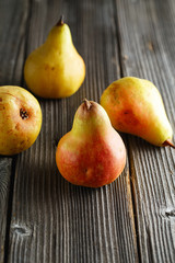 Seasonal fruits. Several tasty ripe juicy pears on a wooden background. veganism, healthy eating and lifestyle