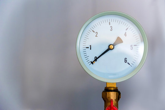 Close up image of white industrial barometer