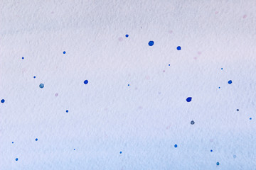 Blurred image of dirty paper. Splashes of blue paint on white paper. Blurred abstract background. 