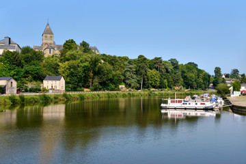 Fototapeta na wymiar Port on Mayenne river at Château-Gontier with the Saint-Jean-Baptiste church in height, commune in the Mayenne department, Pays de la Loire Region, in north-western France