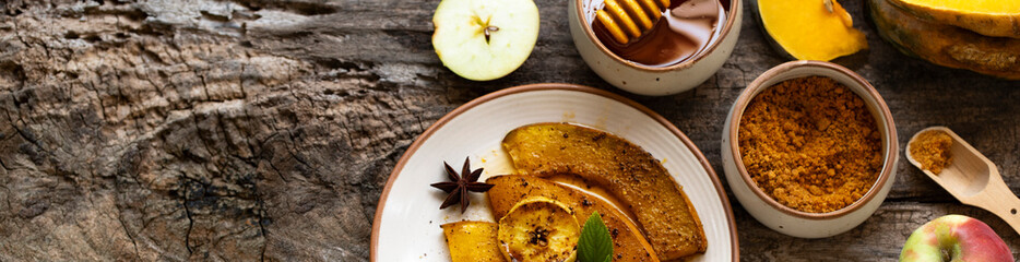Roasted, baked pumpkin with apples, slices and mint. Healthy food concept with copy space. Copy space. Rustic natural style banner. Thanksgiving banner concept.