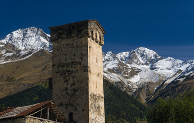 Svaneti tower against high mountains background