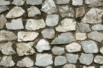Old rough stone wall. Rock gray background.