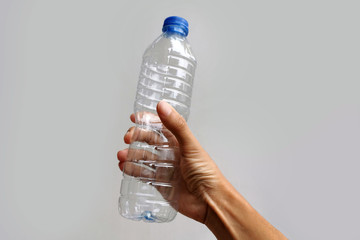 hand holding empty used plastic bottle;recycle concept