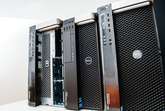 London, United Kingdom - Oct 2, 2017: Row of three new Dell Precision T5810 7910 Xeon workstation for heavy computing AI calculations - once computer is with the open front door for eight HDD