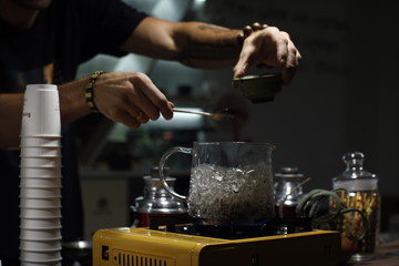 Process brewing tea,tea ceremony,Cup of freshly brewed black tea,warm soft light, darker background.