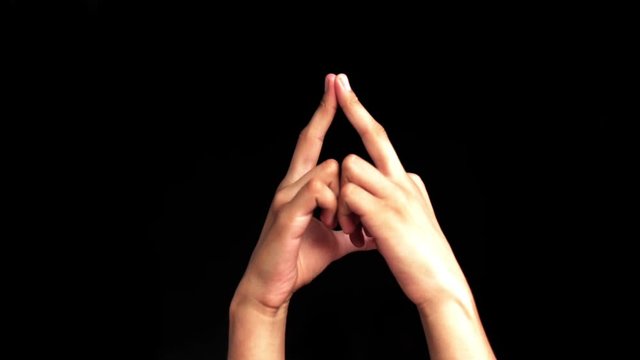 Single human hand of a teenager coming up and doing Mantangi mudra or Matangi Yoga  Hand Gesture isolated on black.