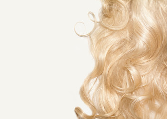 white curly hair on a white background. blonde wig. top view background