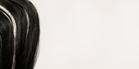 black straight hair on a white background. brunette wig. top view background