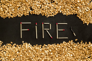 Fire word from matches into kindling frame on black background top view