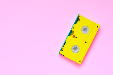 Yellow video tape on color background, VHS, 90s concept