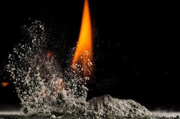 burning sand and a splash of water on a black background, the fifth element