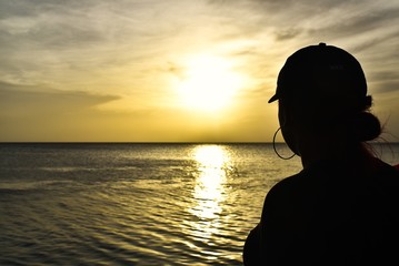 silhouette of a person on the beach at sunset
