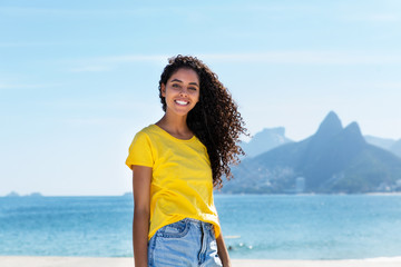 Smiling brazilian woman at Ipanema beach at Rio de Janeiro
