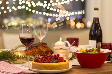 christmas dinner and eating concept - food and drinks on table at home