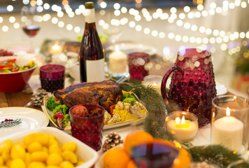 christmas dinner and eating concept - food and drinks on table at home