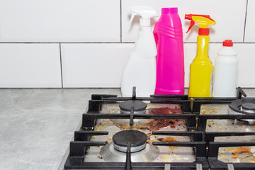 Dirty, top of the gas stove with bits of food. House cleaning.