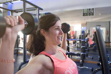 woman training in gym with weights