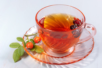 cup of rosehip tea on a wooden table
