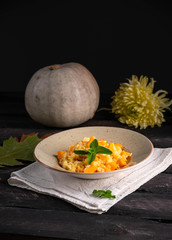 risotto with pumpkin, mint leaf top, pumpkin of the background