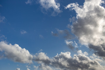 Blue sky with white and dark clouds background