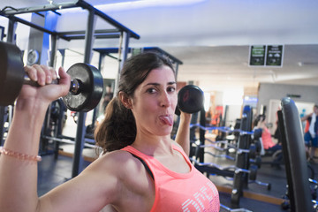 woman training in gym with weights
