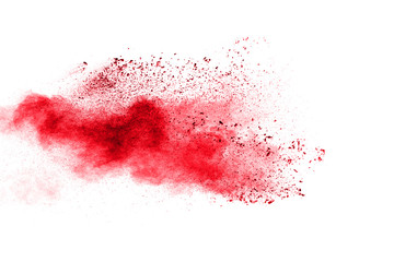 Red powder explosion cloud on white background. Freeze motion of red color dust  particles splashing.